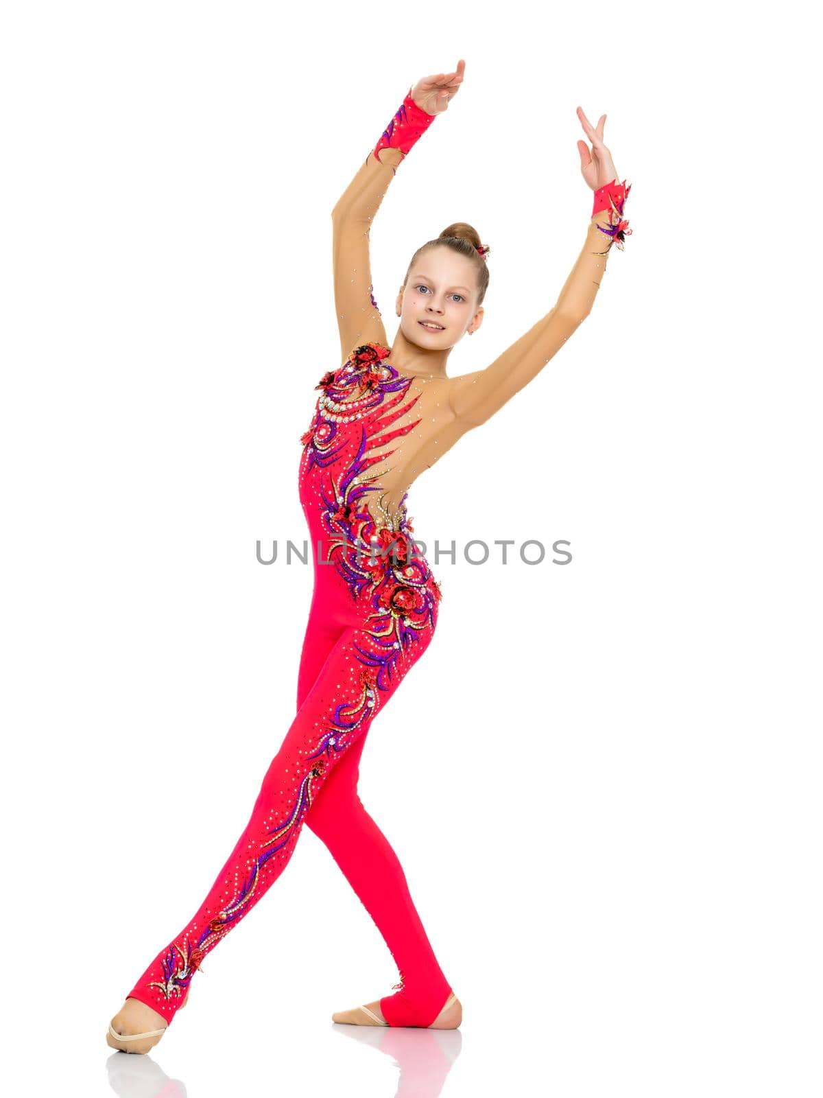 A nice little girl gymnast, in a beautiful gymnastic swimsuit for competitions. In full growth. The concept of advertising sports goods, the physical development of children. Isolated on white background.