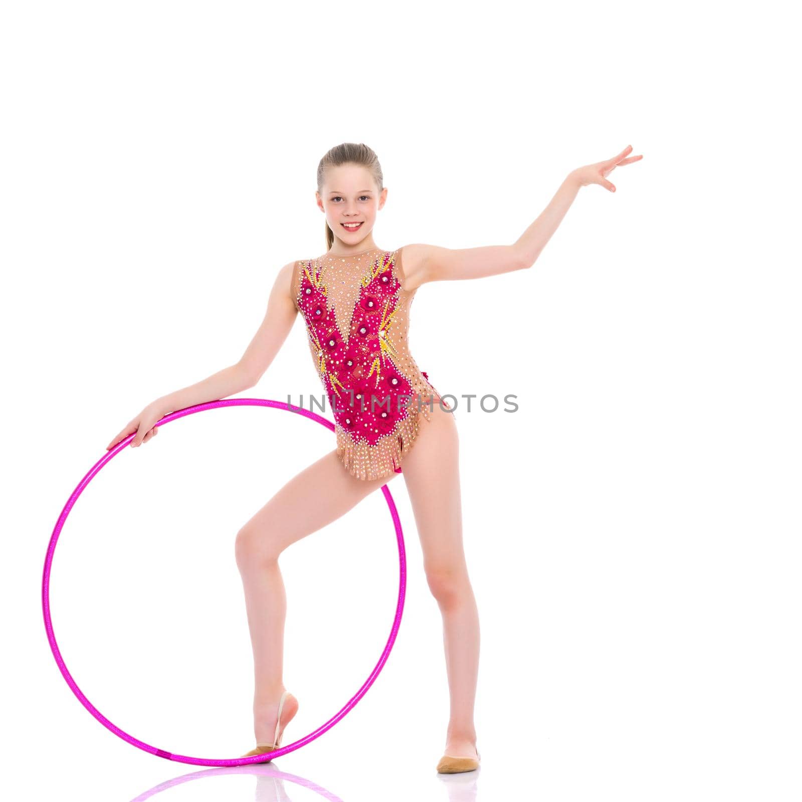 A girl gymnast performs an exercise with a hoop. The concept of gymnastics and fitness. Isolated on white background.