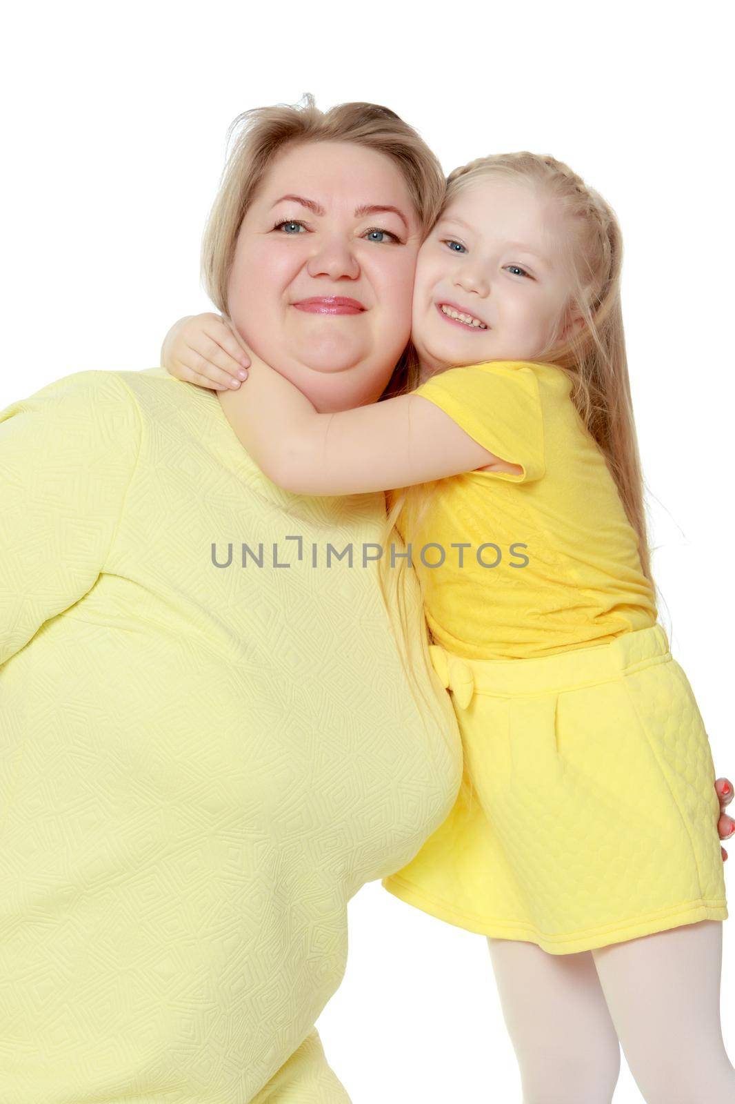 Mom and little daughter plus the size of the model, gently embrace. A woman and her daughter are smiling in a happy manner. Good for the concept of health, happiness, diet, obesity, weight loss.