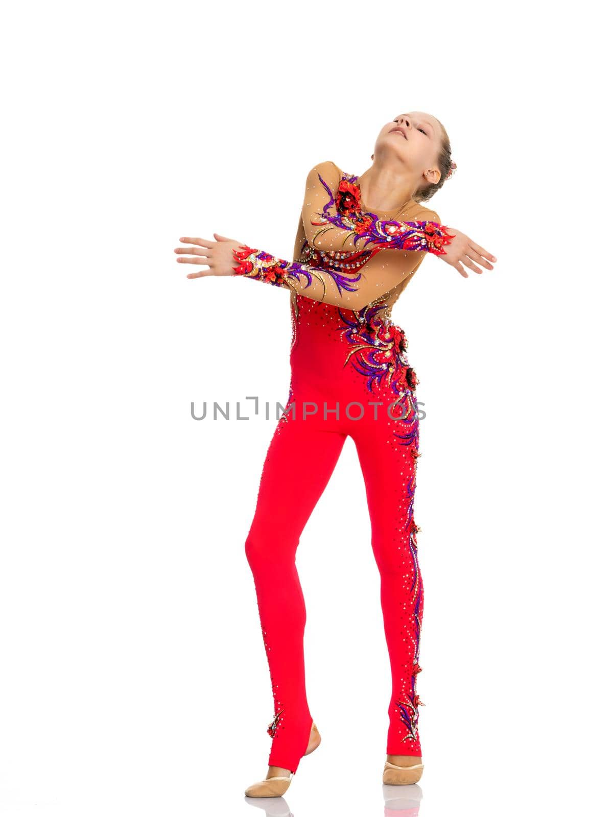 A nice little girl gymnast, in a beautiful gymnastic swimsuit for competitions. In full growth. The concept of advertising sports goods, the physical development of children. Isolated on white background.