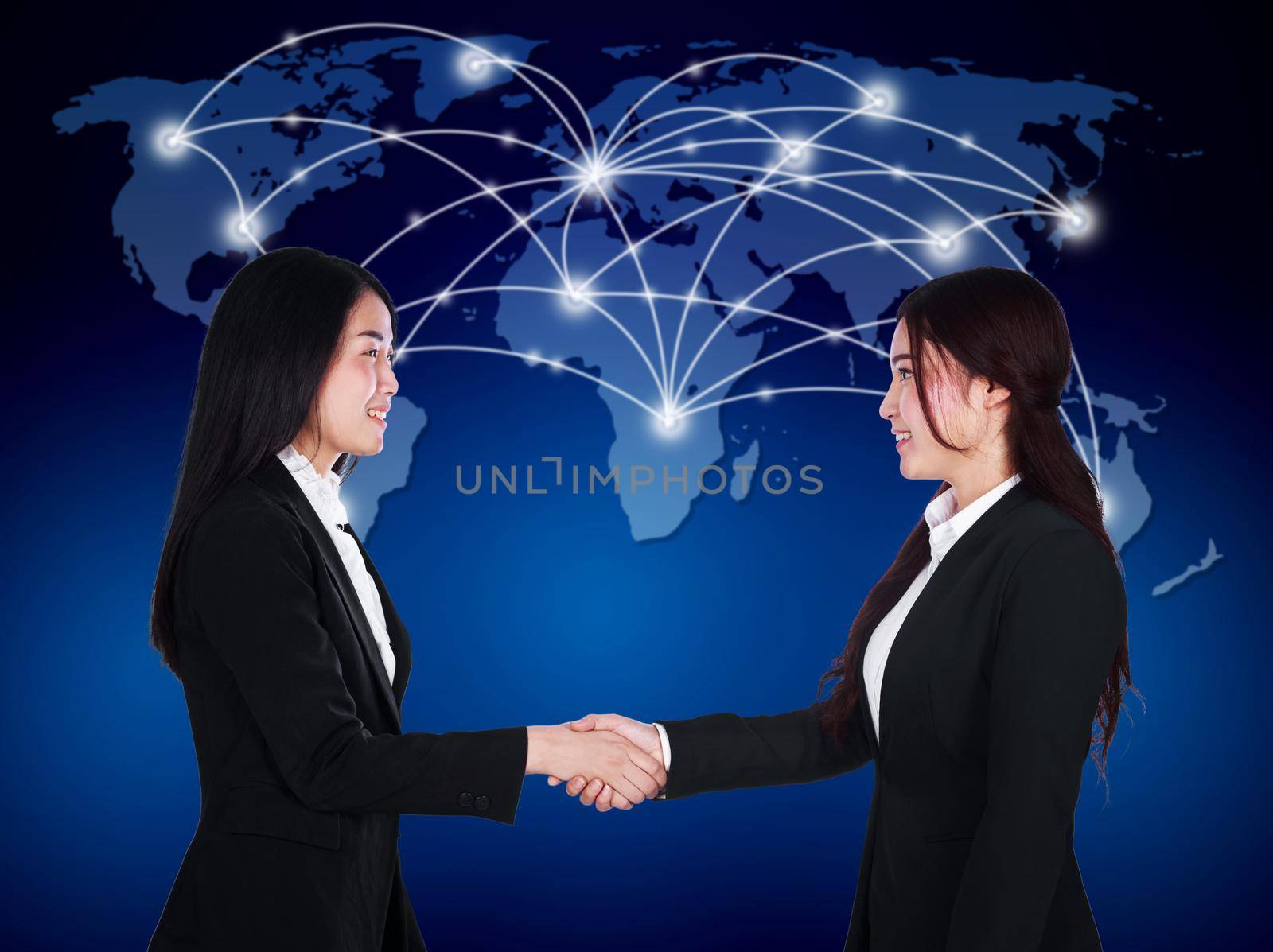 two happy young businesswomen shaking hands  by geargodz