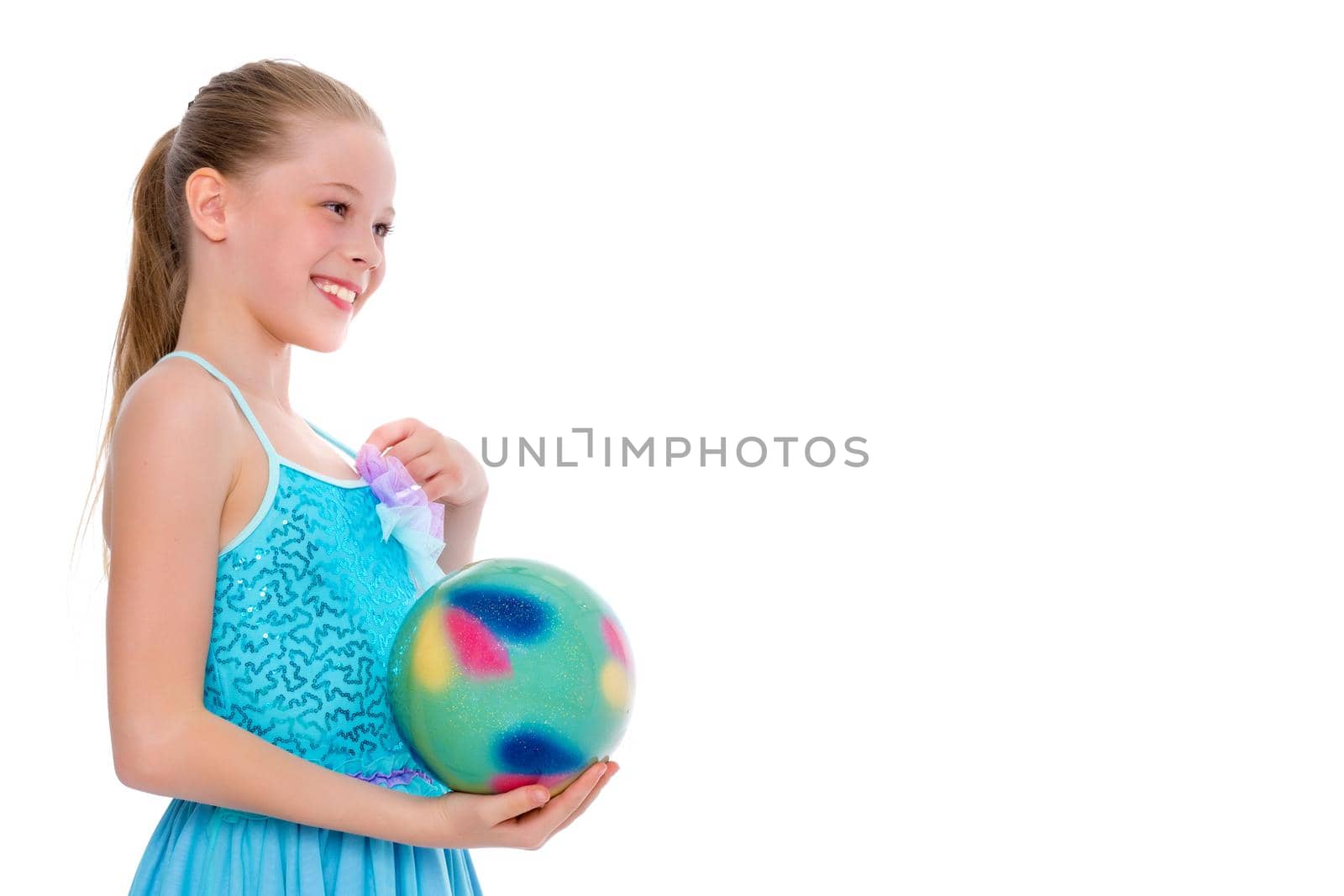 Beautiful little girl gymnast performs exercises with the ball. The concept of children's sports, fitness. Isolated on white background.