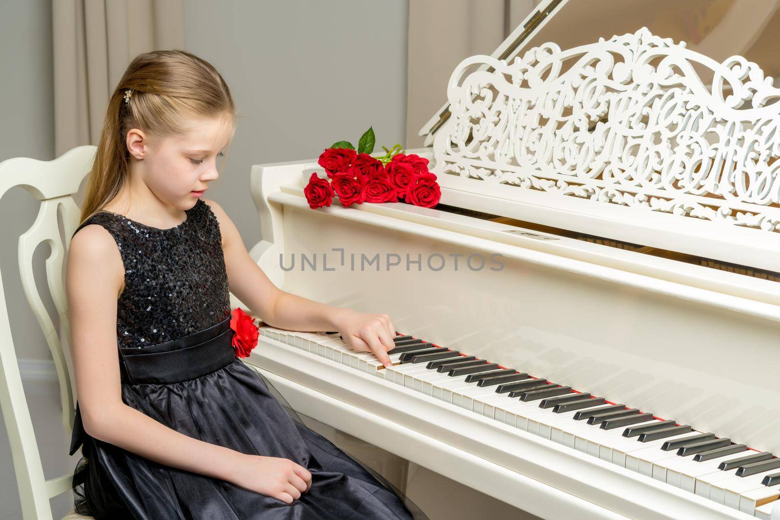 Girl schoolgirl near the piano on which lies a bouquet of flower by kolesnikov_studio
