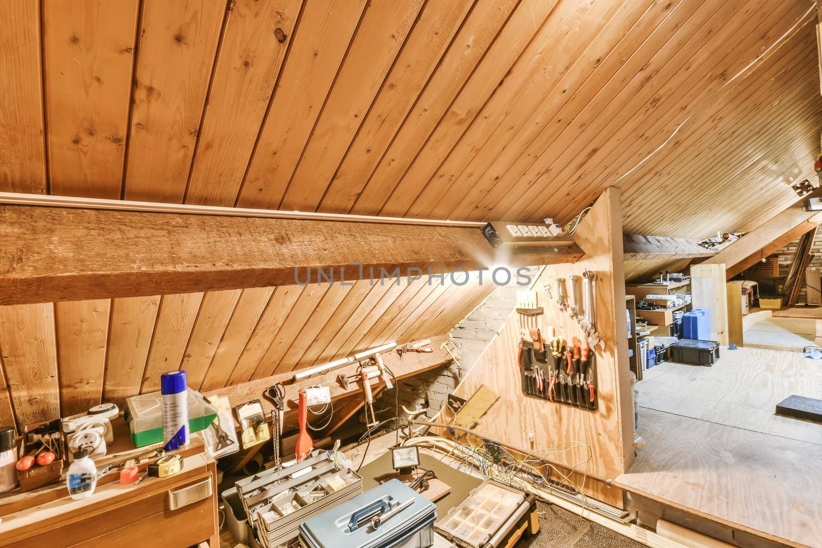 Convenient attic with tools in stylish house