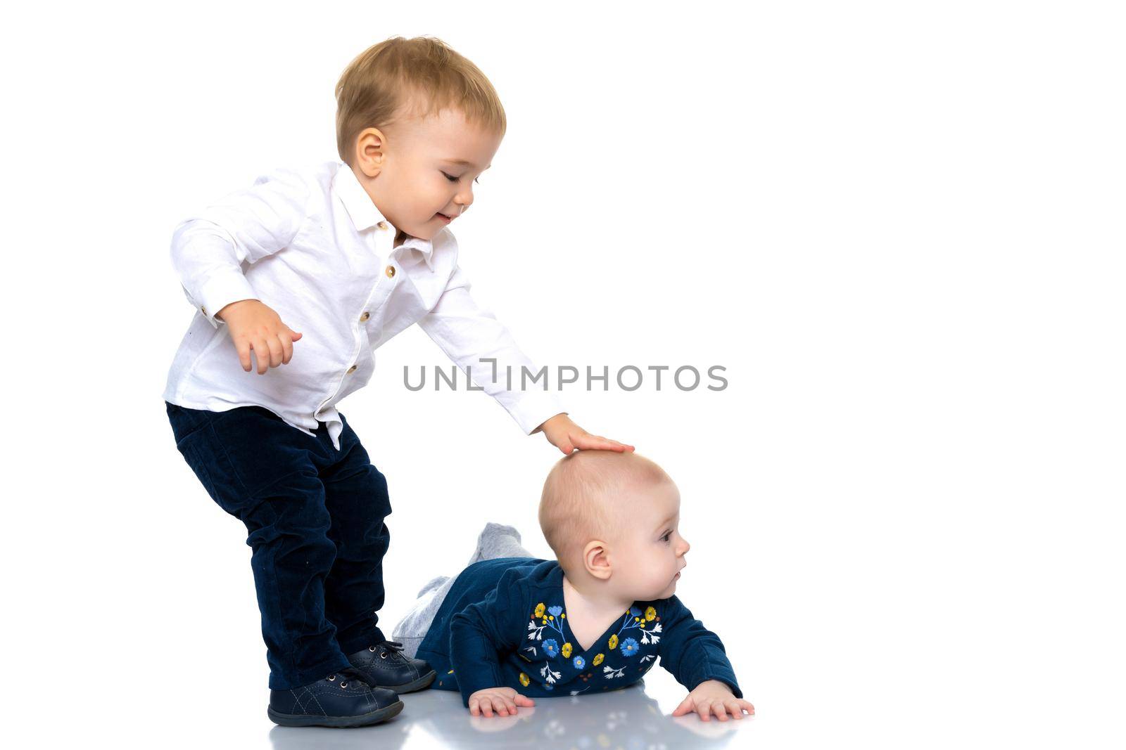 Toddler boy and girl, cute hugging in studio on a white background. The concept of a harmonious development of a child in the family, a happy childhood. Isolated.