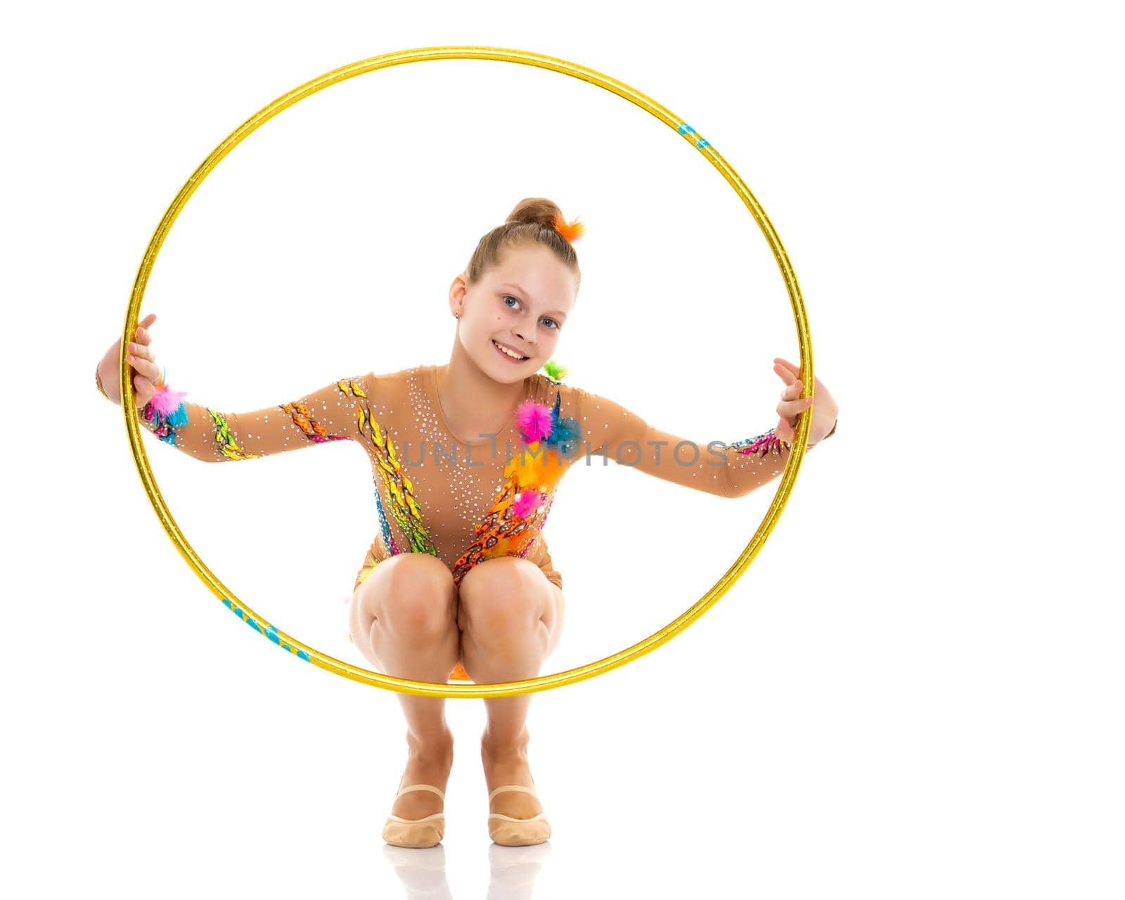 A girl gymnast performs an exercise with a hoop. The concept of gymnastics and fitness. Isolated on white background.