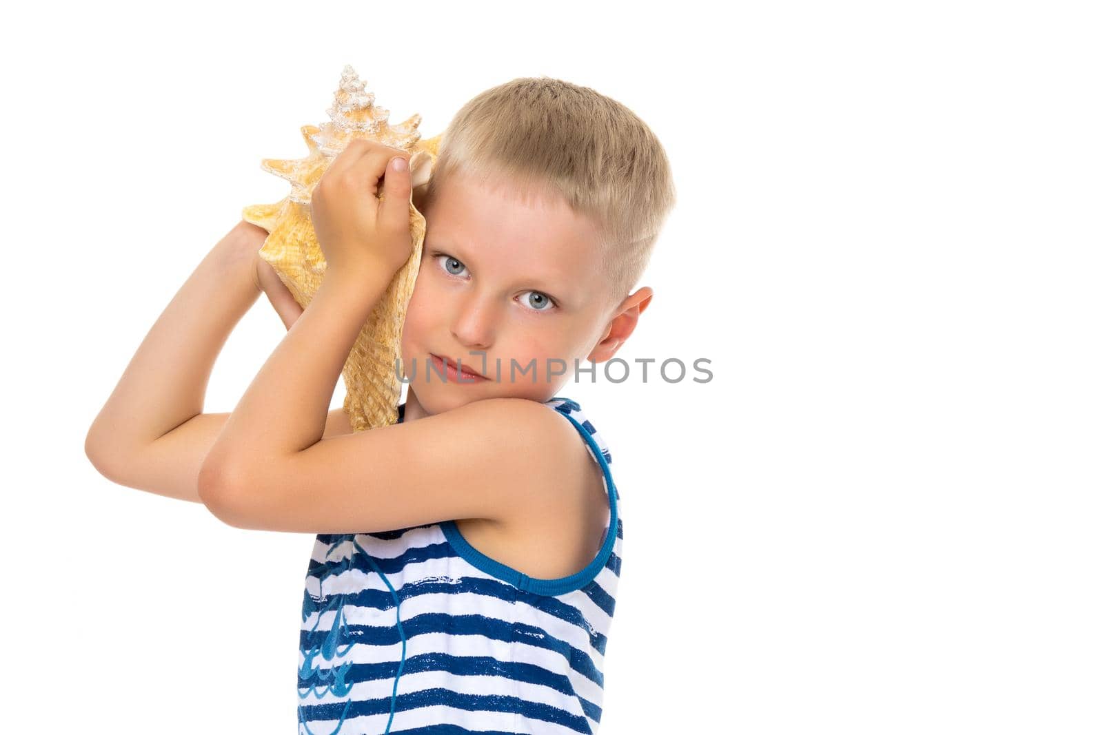 A cute little boy with a sea shell. The concept of a family vacation at sea, advertising of summer tourism. Isolated on white background.