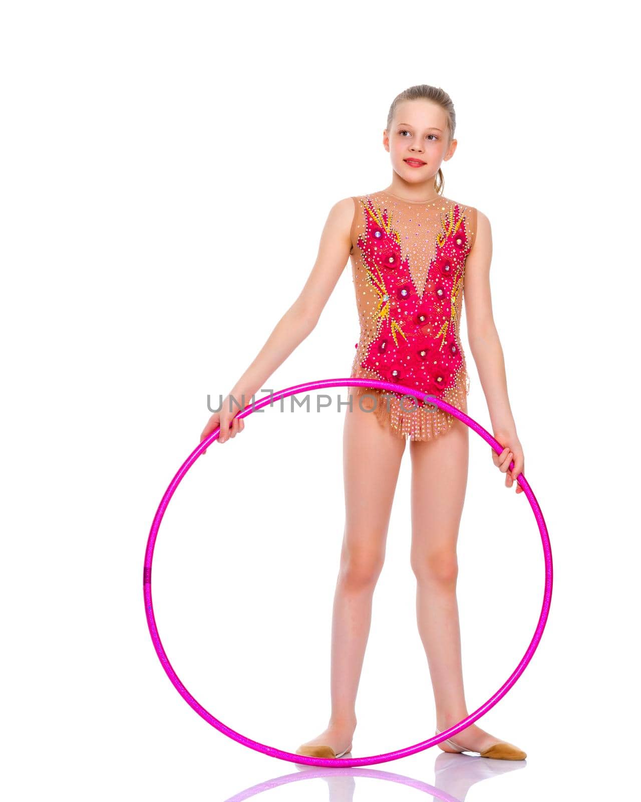 A girl gymnast performs an exercise with a hoop. The concept of gymnastics and fitness. Isolated on white background.