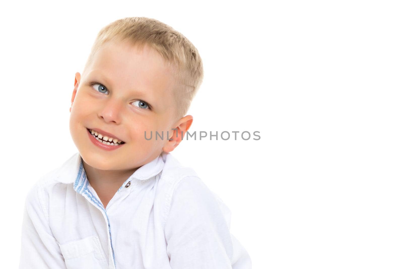 Smiling little boy, studio portrait on white background. The concept of a happy childhood, well-being in the family. Close-up. Isolated.