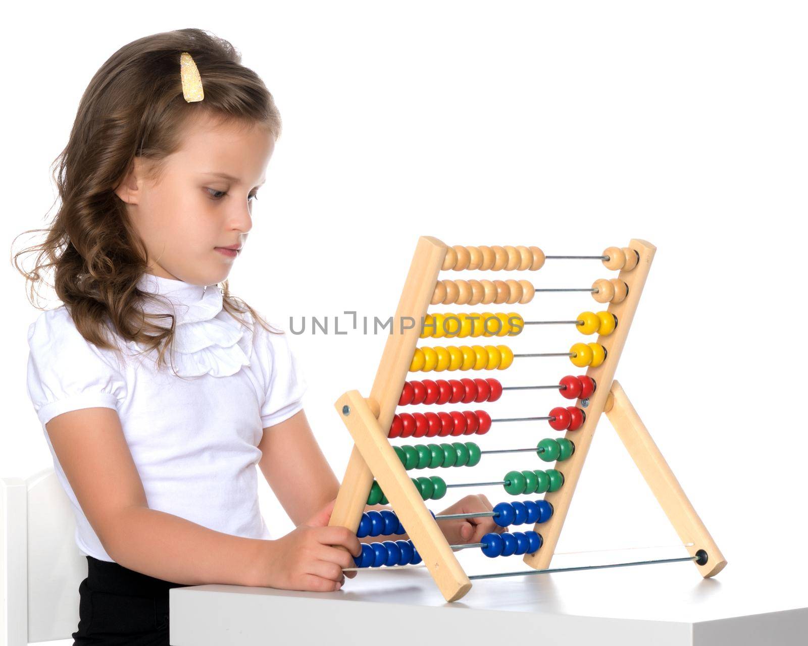 The girl counts on abacus.The concept of happiness, people, family, child, childhood, teaching math at school or kindergarten. Isolated on white background