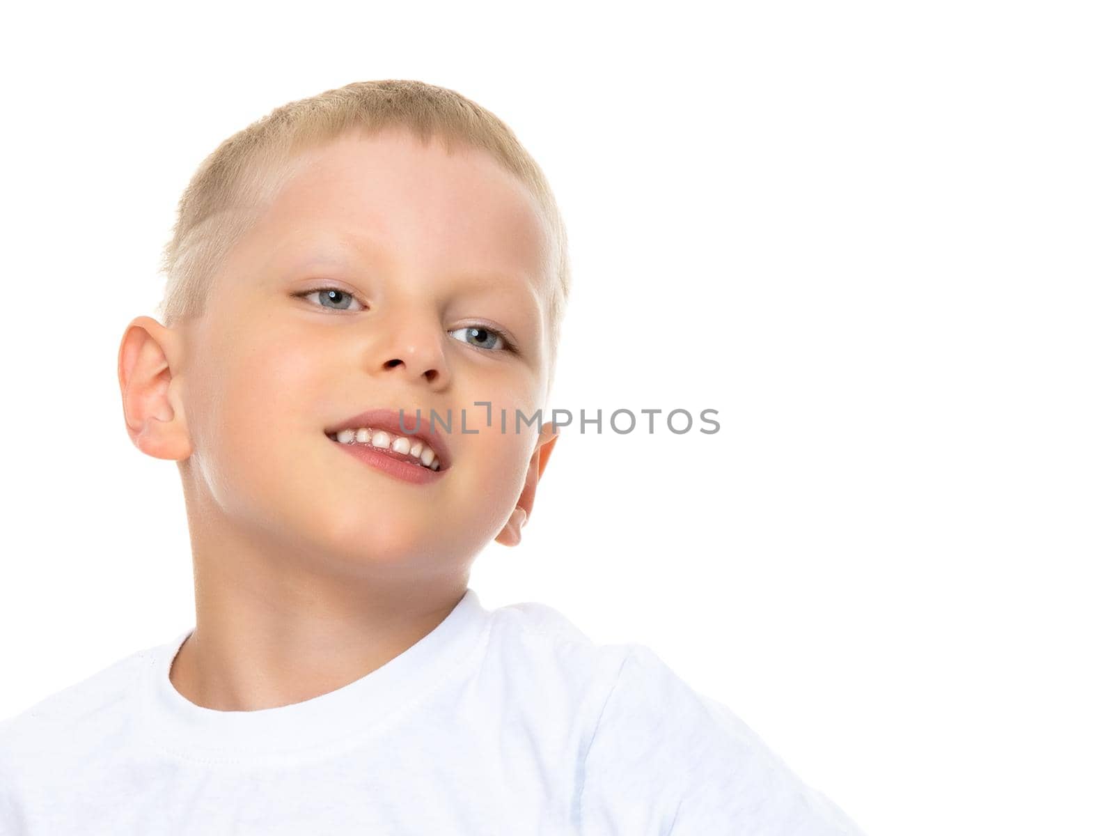 Smiling little boy, studio portrait on white background. The concept of a happy childhood, well-being in the family. Close-up. Isolated.
