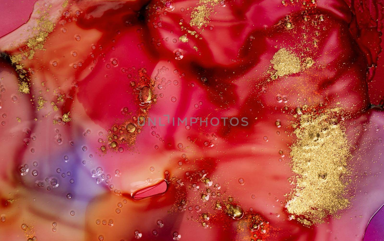 Dark red watercolor ink stains under transparent liquid with bubbles and gold particles