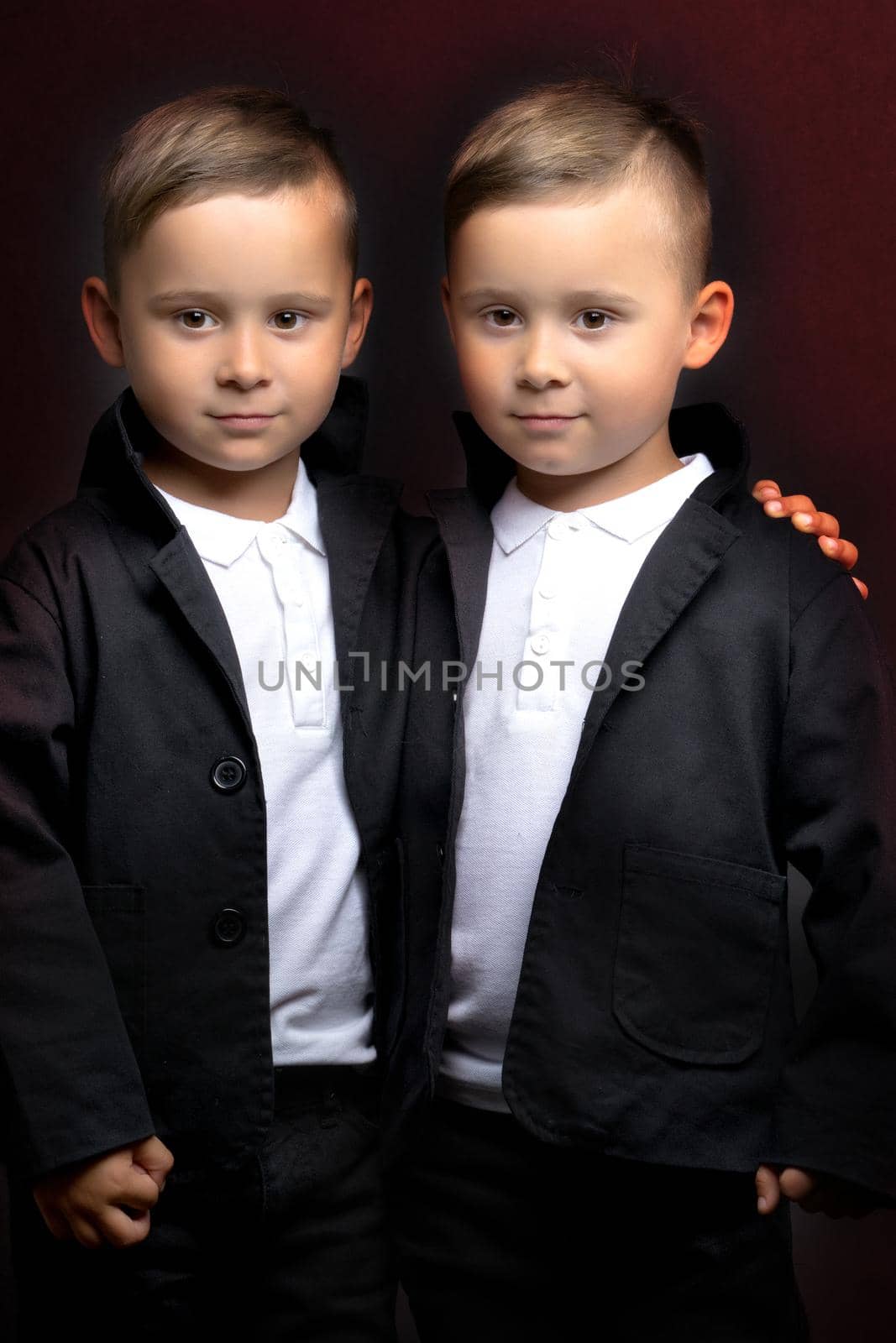 Two beautiful boys in black suits by kolesnikov_studio