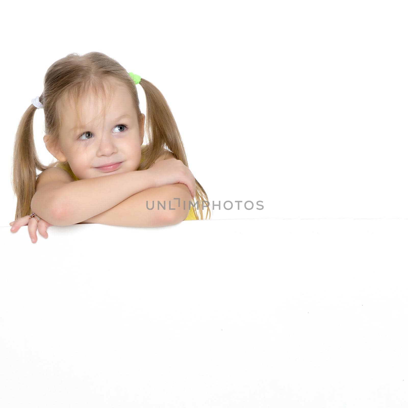 A nice little girl thinks. The concept of education and school, children's creativity. Isolated on white background.
