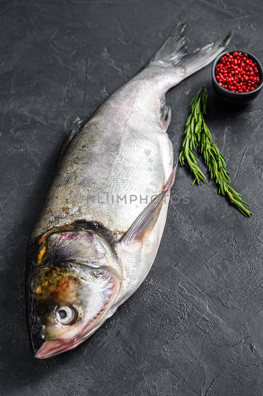 Raw whole fish silver carp. Black background. Top view.
