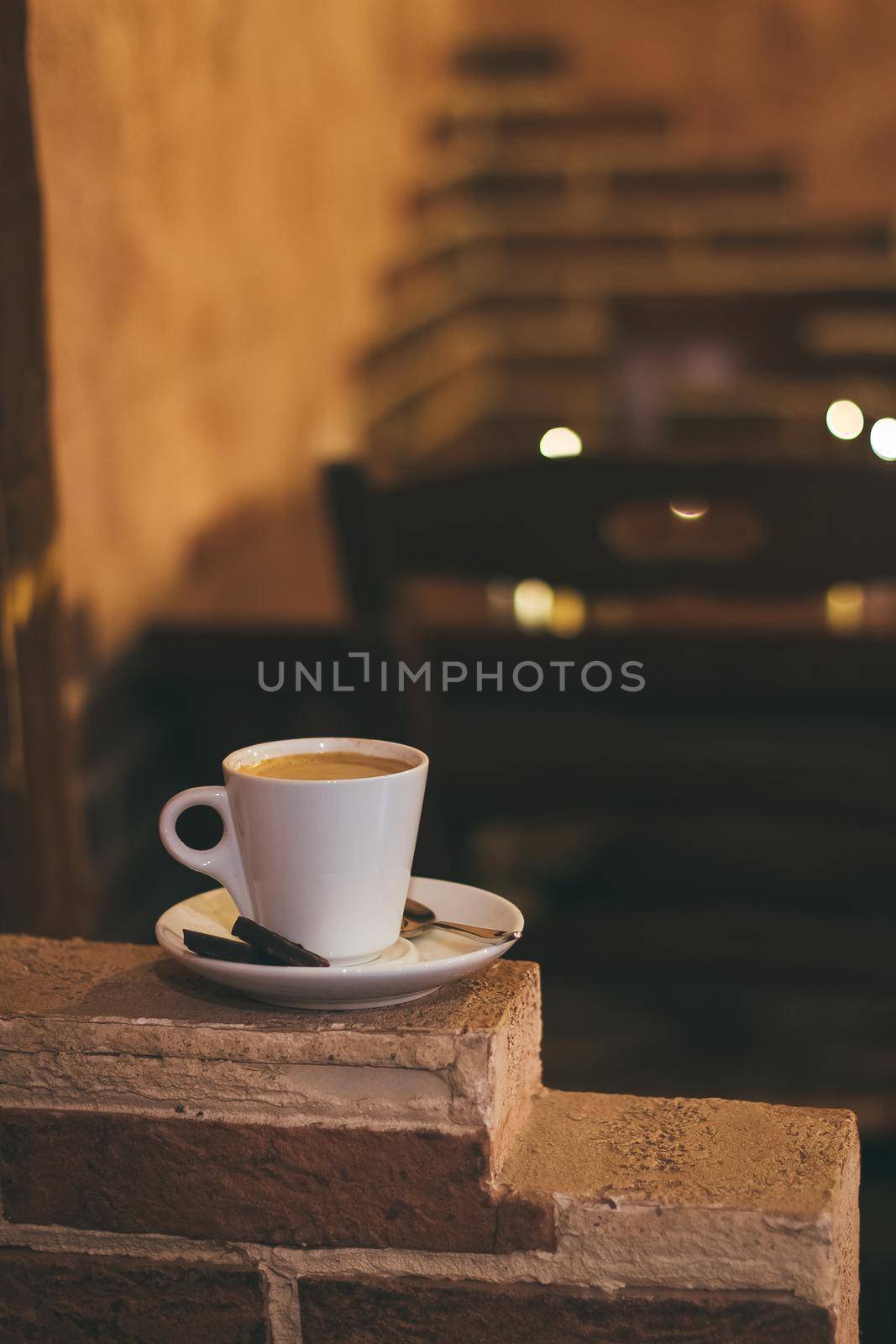 Cup of hot coffee on table in cafe. Vintage and retro color effect - shallow depth of field by mmp1206