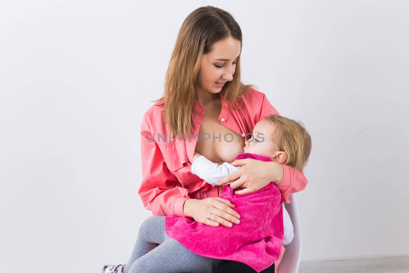 Motherhood concept - Mother and baby lactation on white background