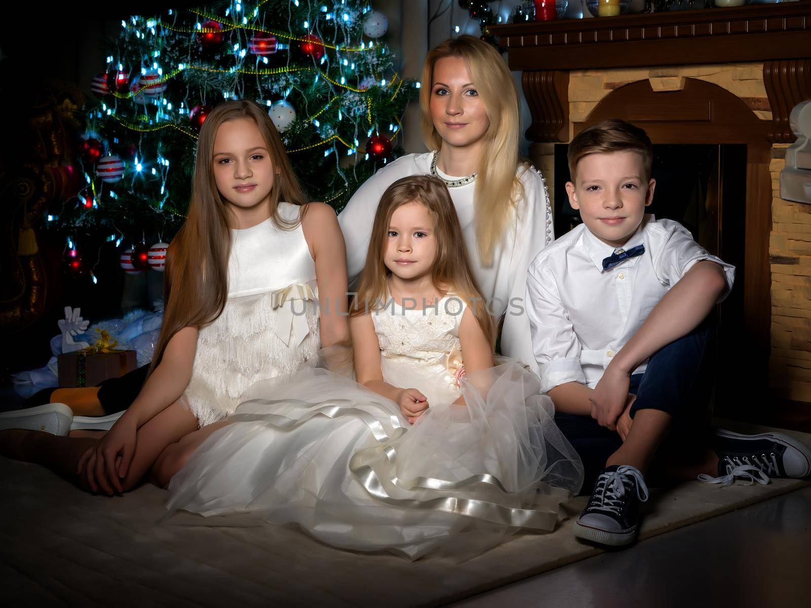 Big happy family with children near the Christmas tree. by kolesnikov_studio