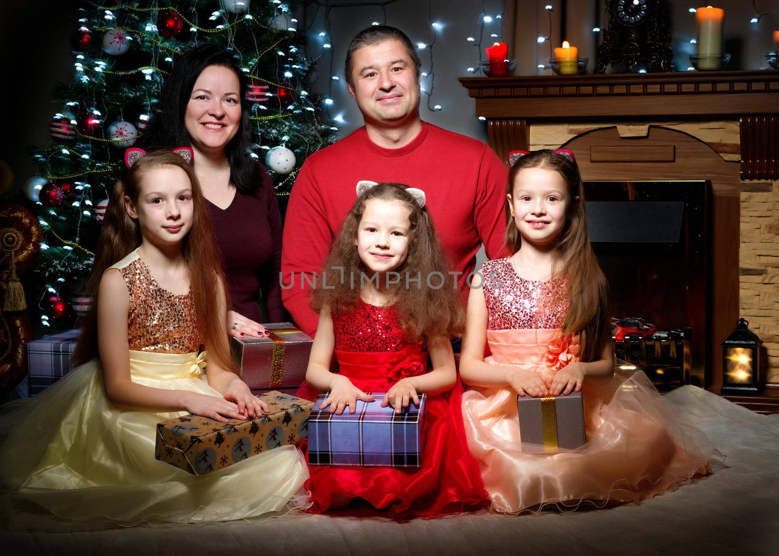Big happy family with children near the Christmas tree. by kolesnikov_studio