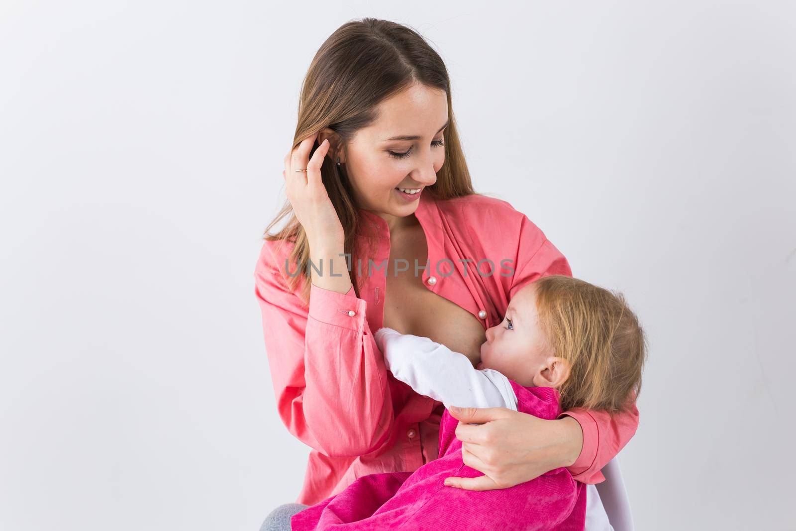 Mother breast feeding and hugging her baby.