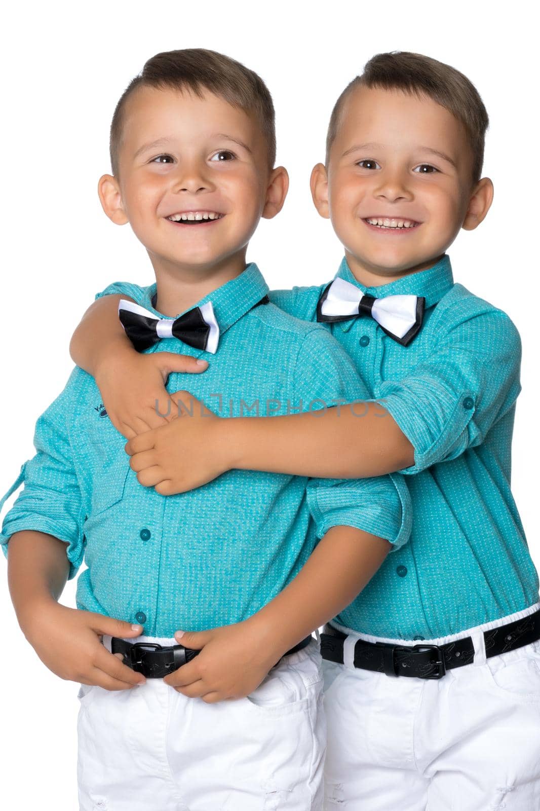 Two cute little boys, brothers close-up. The concept of a happy childhood, the development of a child in the family. Isolated on white background.