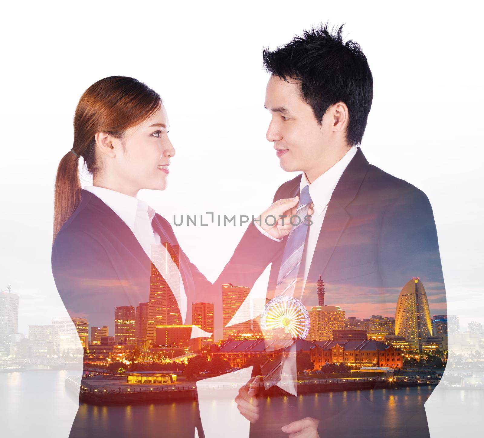 double exposure of business woman's hands adjusting neck tie of man in suit with city background by geargodz