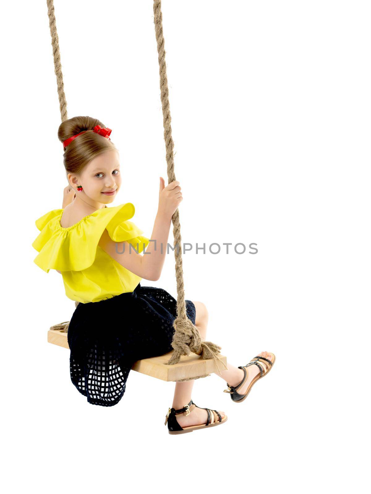 Happy little girl gaily swinging on a swing. The concept of a summer vacation in nature, a family vacation with the family on the beach or the sea. Isolated on white background.