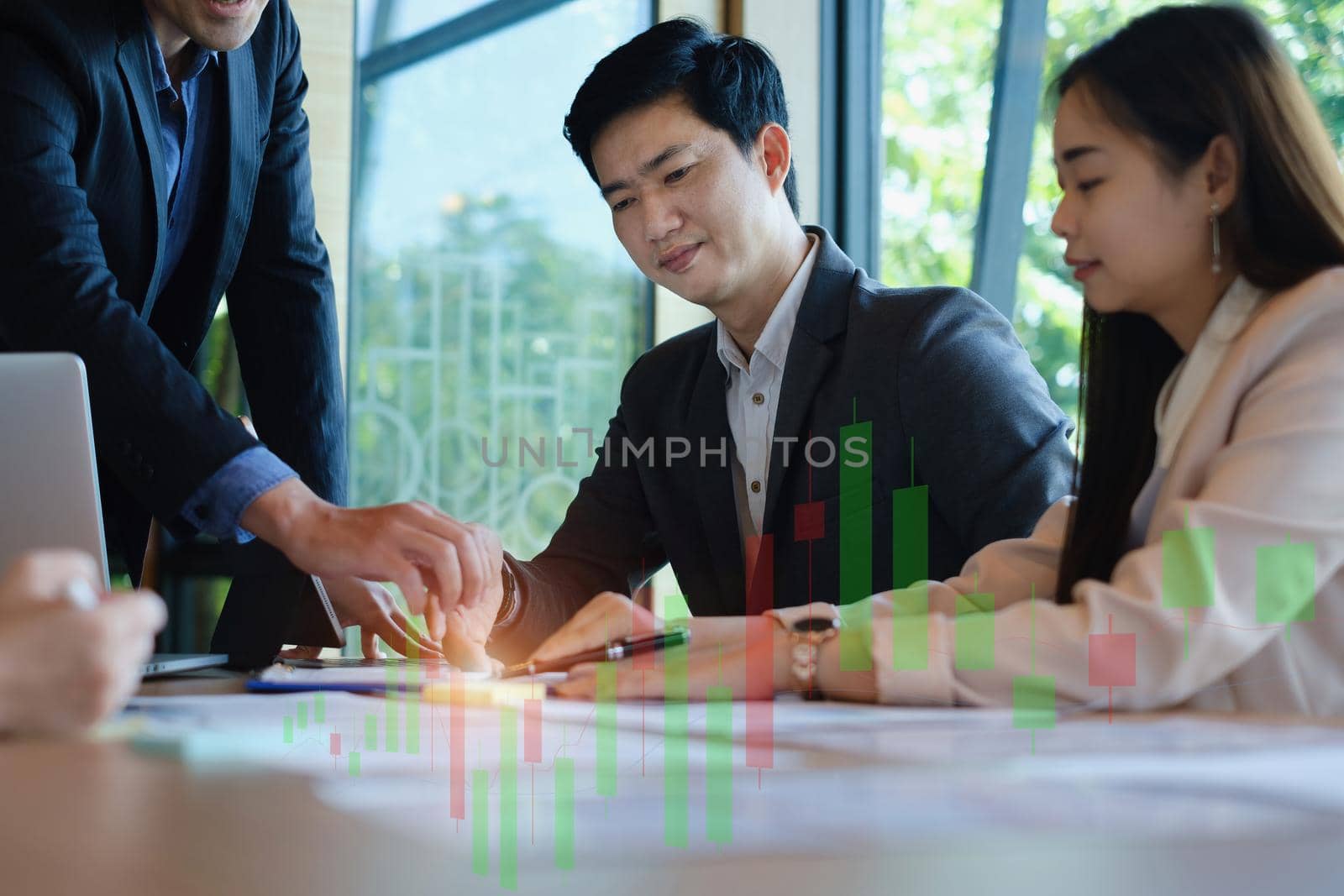 Business team working together and training to analyze technical price graph and indicator. Chart and stock trading computer screen