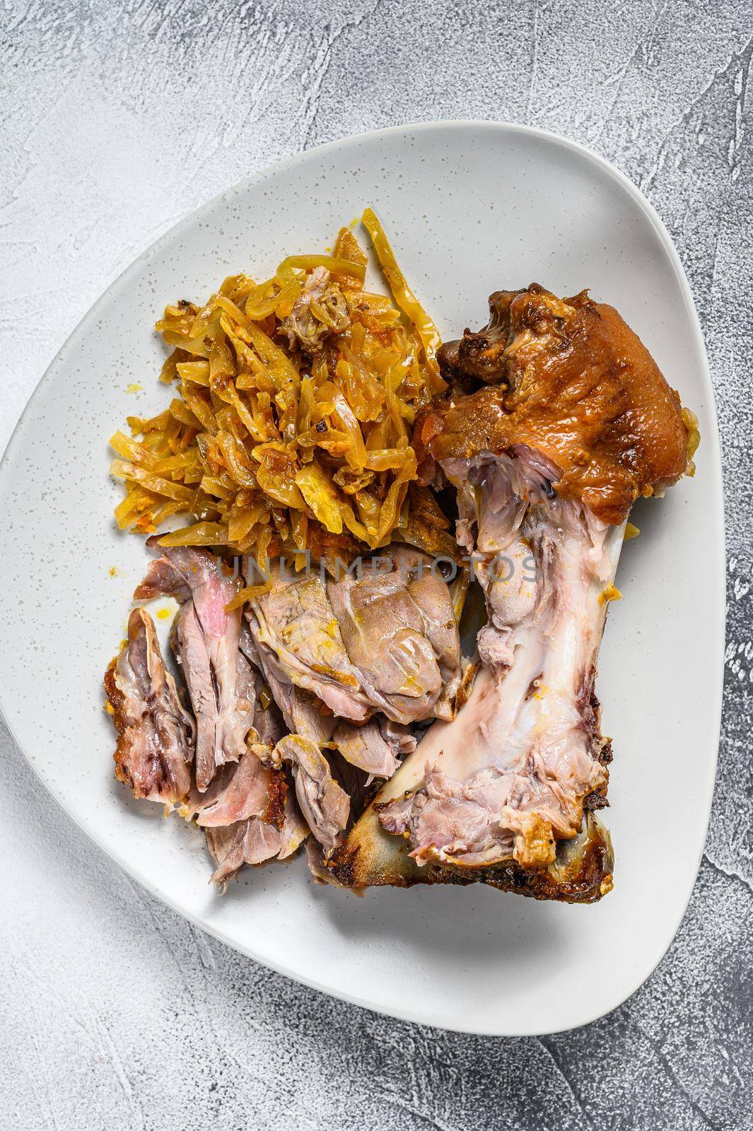 Pork leg eisbein with braised cabbage. Gray background. Top view.