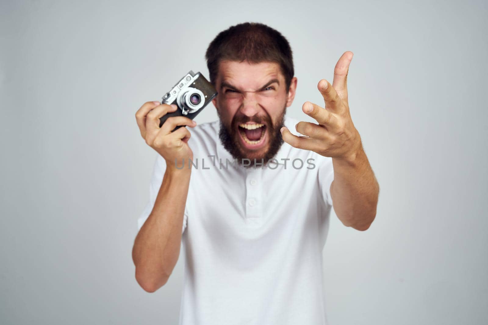 man holding camera professional photographer home light background. High quality photo