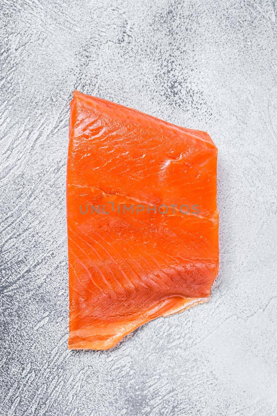 Smoked salmon fillet on a wooden table. White background. Top view by Composter