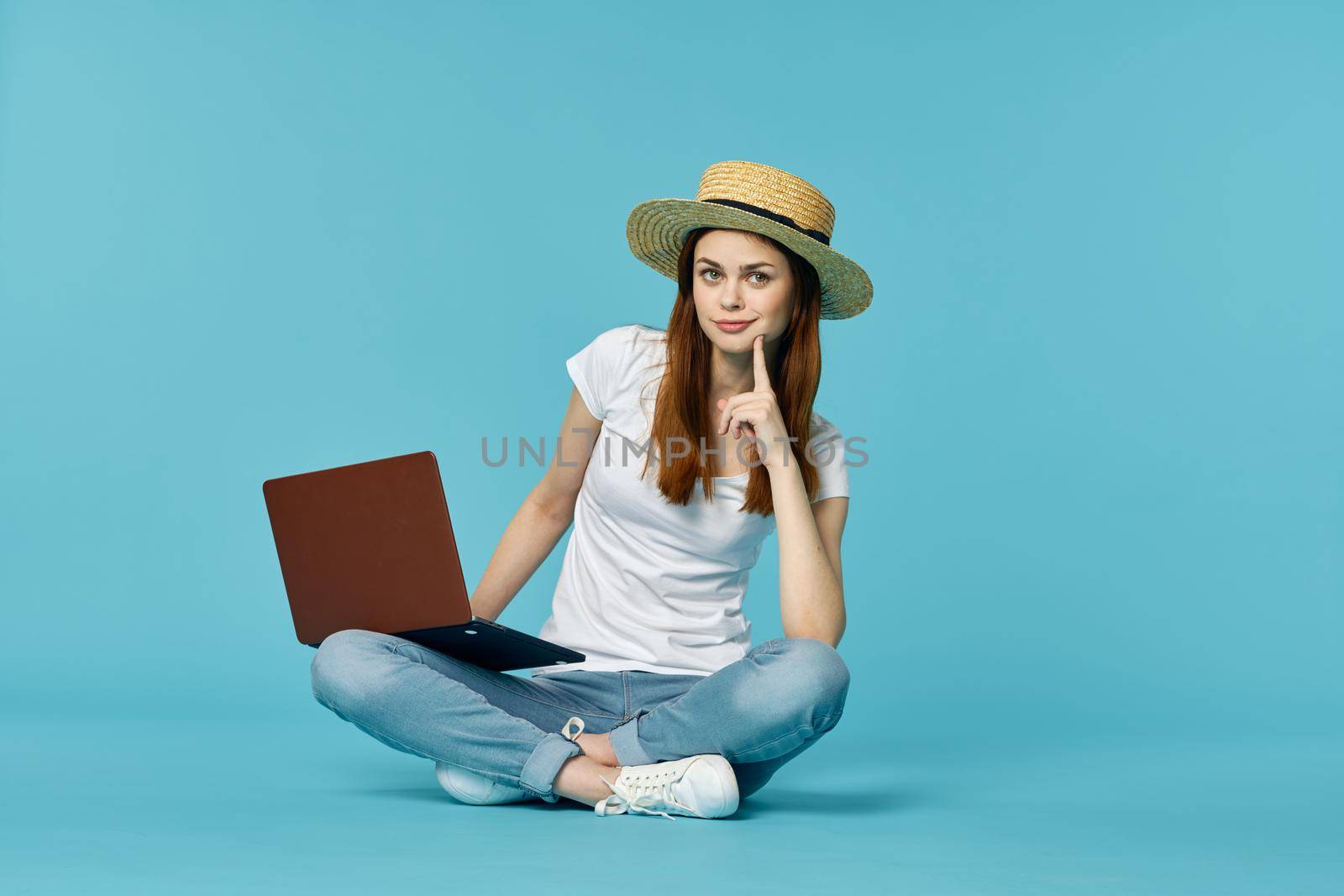 woman with laptop learning internet online education blue background. High quality photo