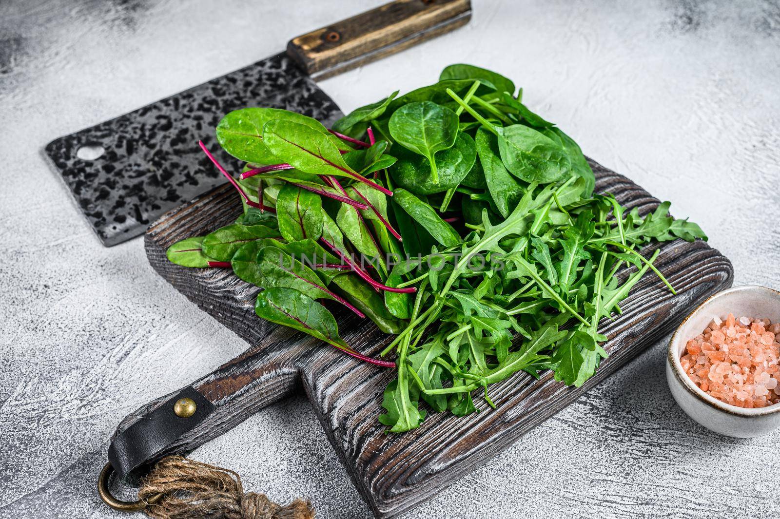 Fresh mixed greens, spinach, swiss chard and arugula. White background. Top view.