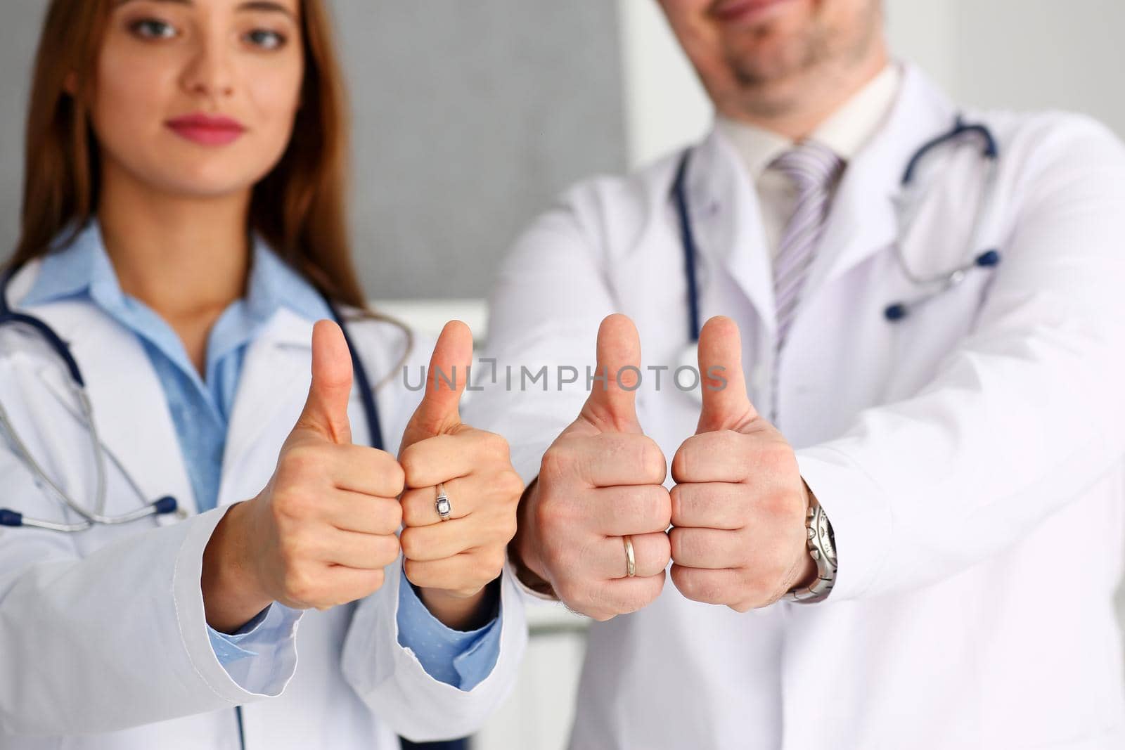 Group of doctor arms show OK or confirm sign with thumb up closeup. High level therapy, great heal participation, healthy lifestyle, satisfied patient, therapeutist, best consultation, physical