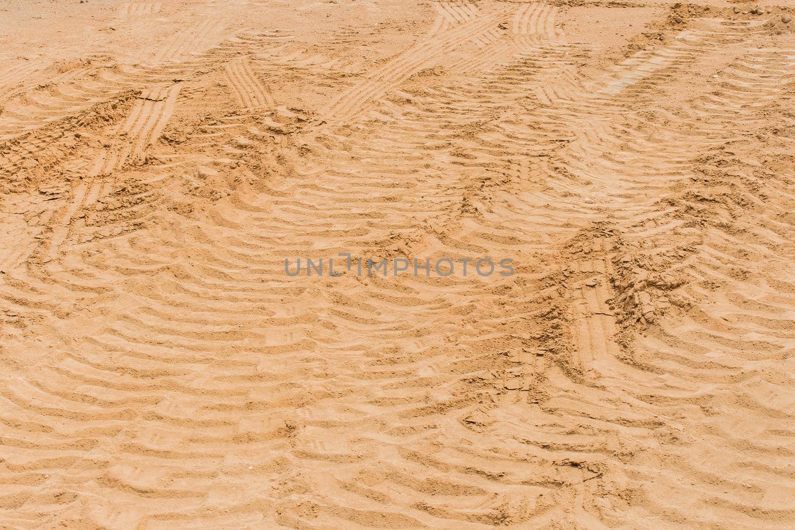 Industrial vehicle tracks on the sand road wheel tire trail at a construction site by AYDO8