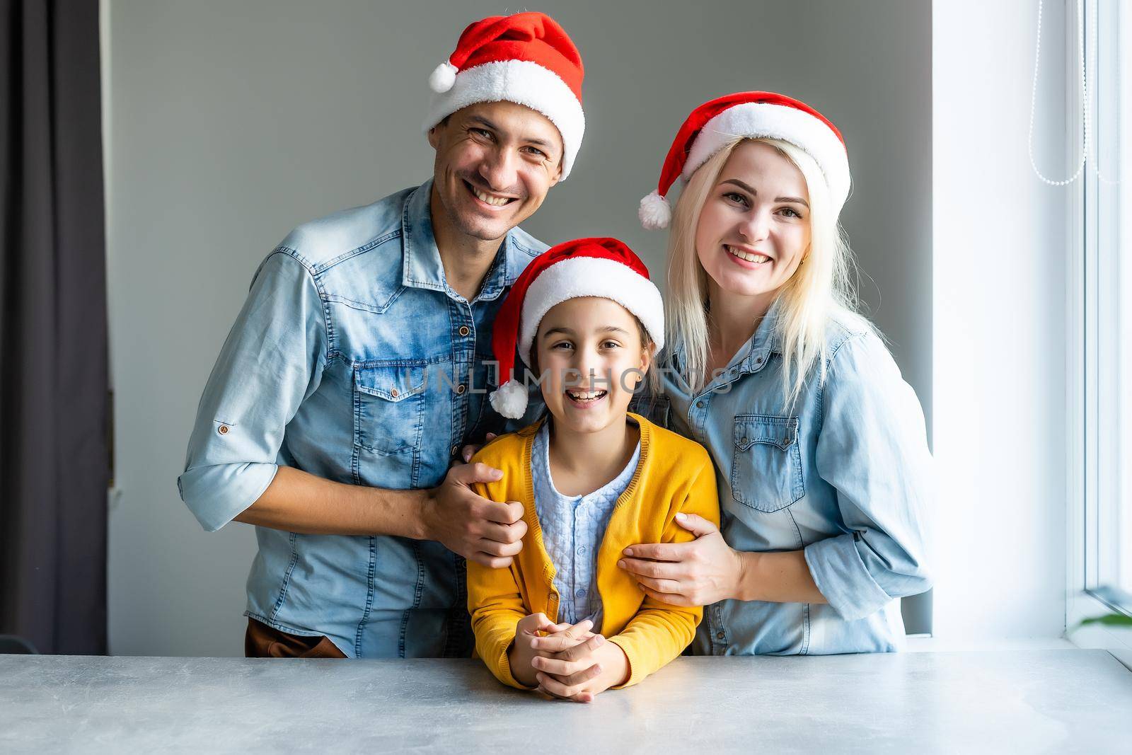 Portrait of happy family in Santa caps