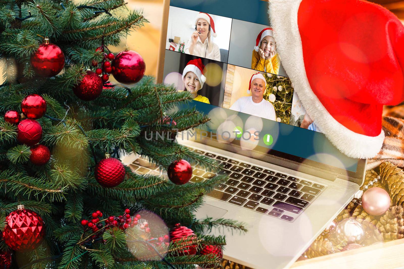 video call with happy diverse children on laptop computer in his workshop. Self-isolation and virtual online celebration at home concept. Christmas by Andelov13