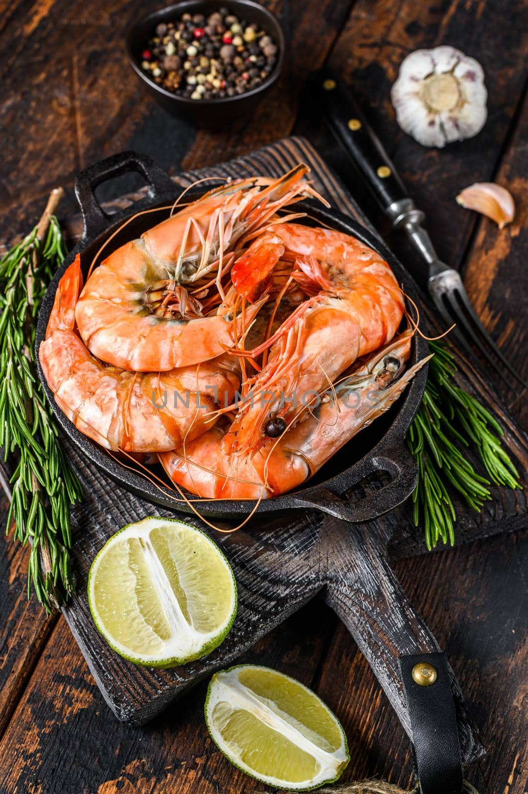 Red Tiger shrimps Prawns in a pan. Dark wooden background. Top view by Composter