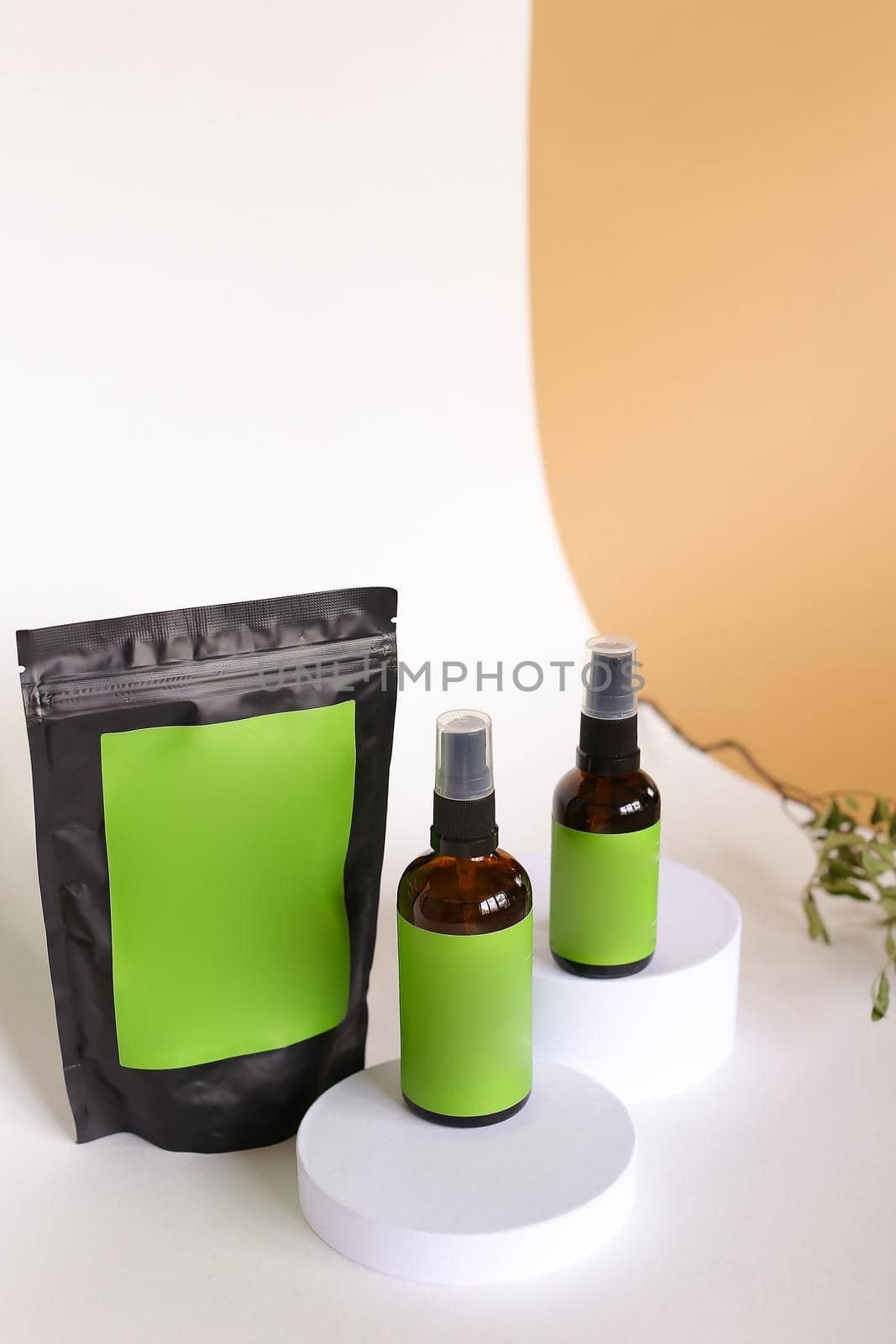 Close up black doy pack and two spray bottles with cosmetic product, green space for brand. by sisterspro