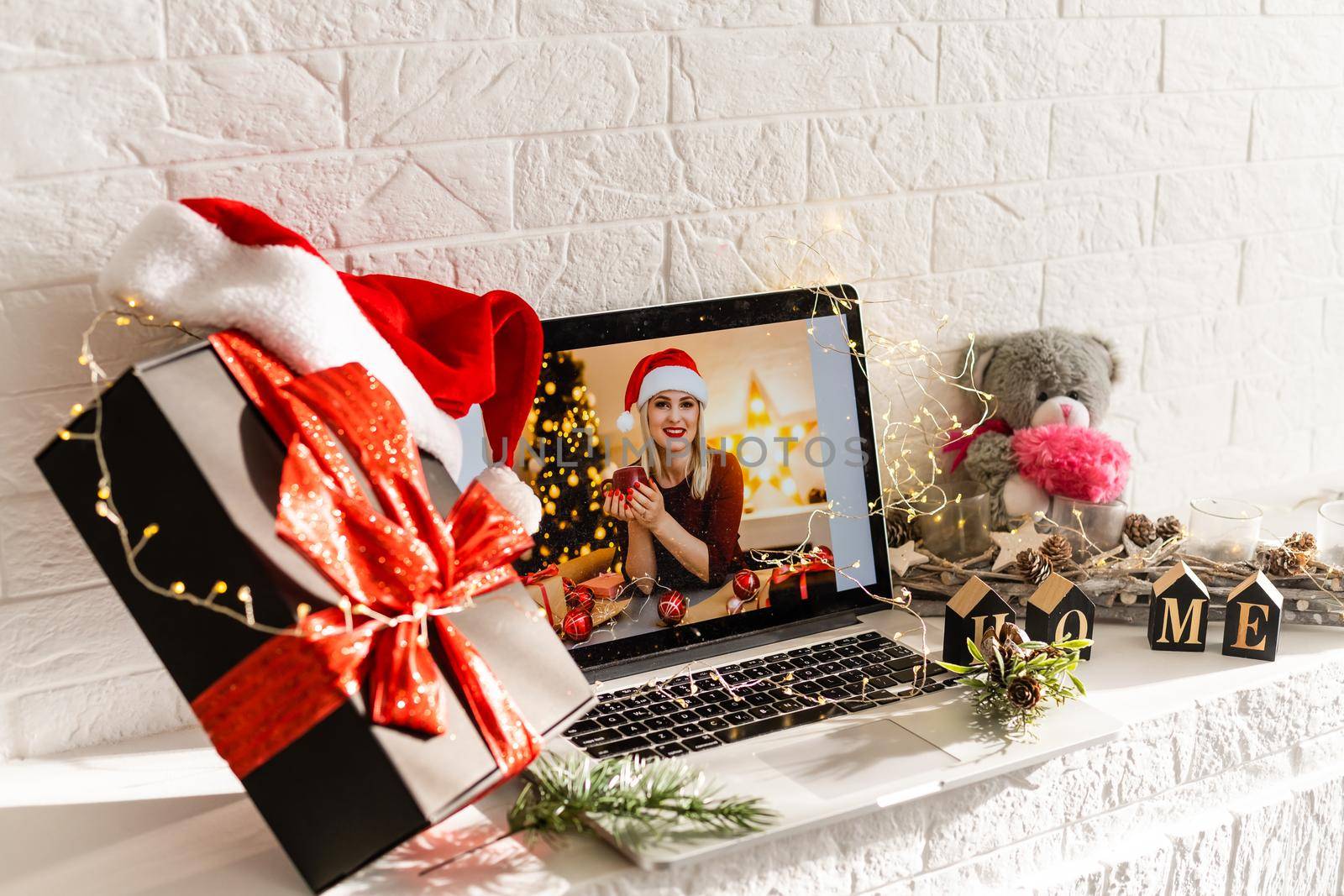 Laptop on the christmas table. Video call with the family in times of coronavirus