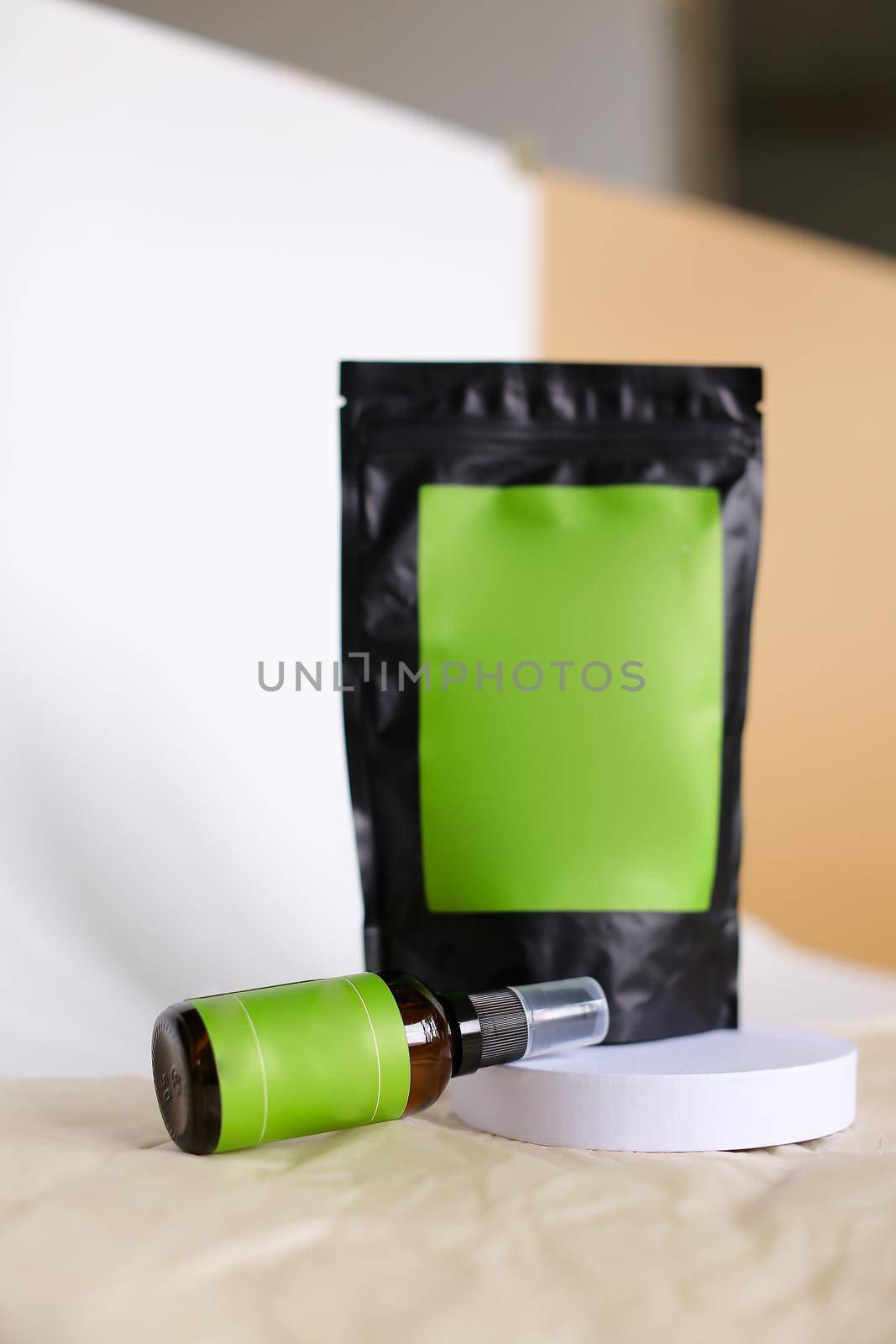 Close up black doy pack and spray bottle with cosmetic product, green space for brand. by sisterspro
