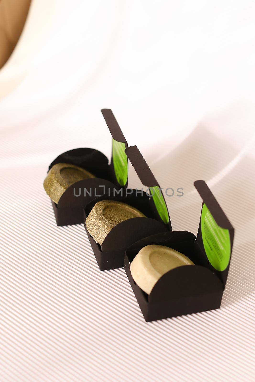 Three soap solid bars in black boxes on white background. Concept of organic cluelty free, kosher cosmetic online shop and pampering.