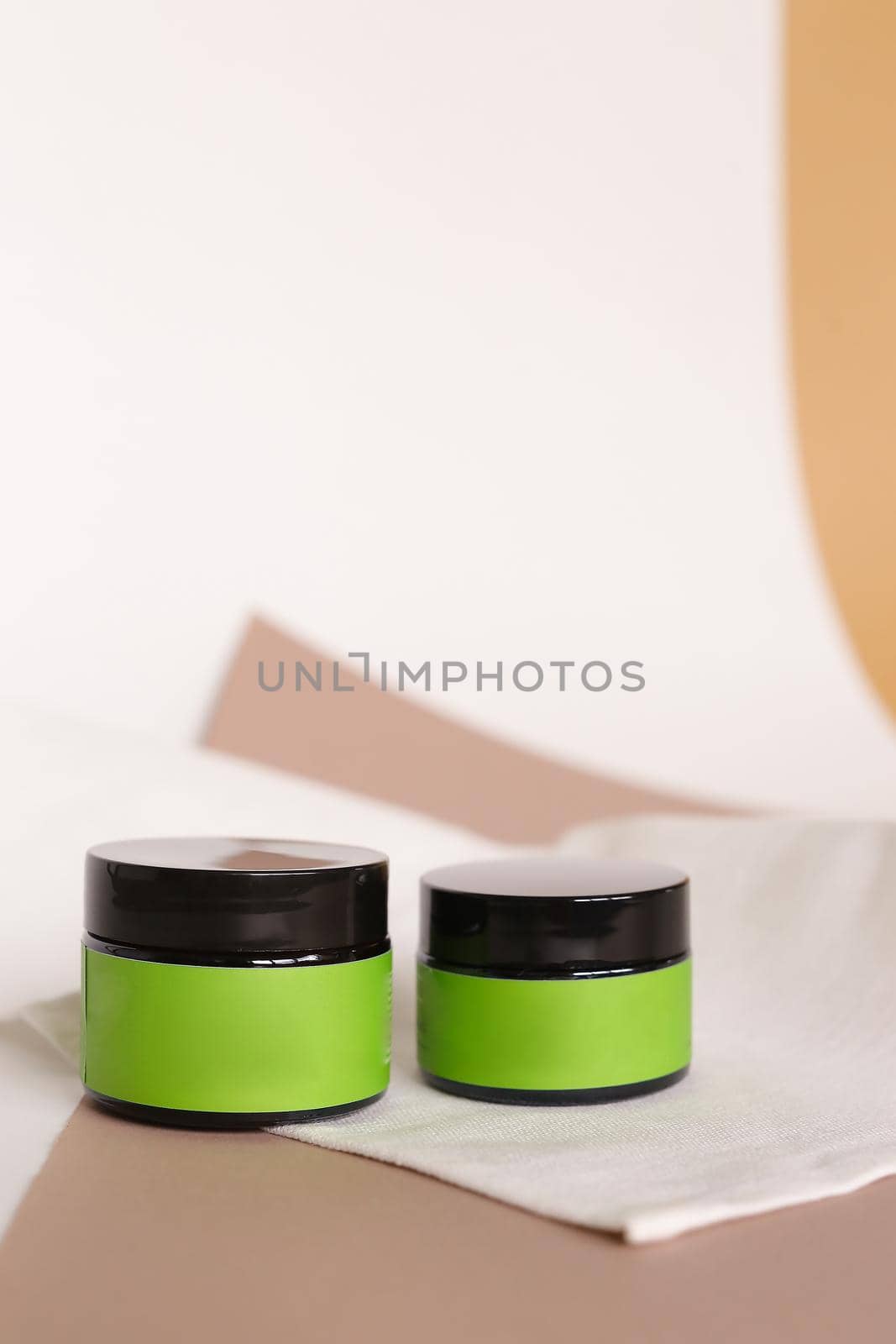 Focus on two jars of facial cosmetic cream with green space for brand. Concept of cluelty free, organic, kosher cream is great for dry and rough skin.