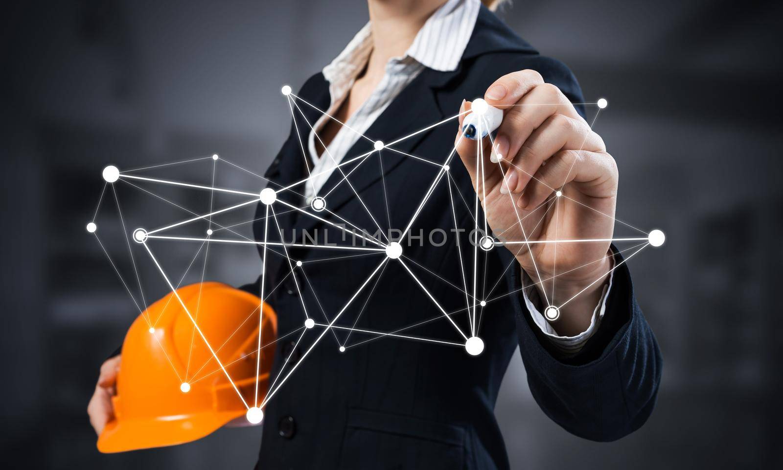 Businesswoman pointing on abstract 3d network. Woman engineer in business suit holding safety helmet. Engineering and project management. Social connection and networking concept with plexus structure