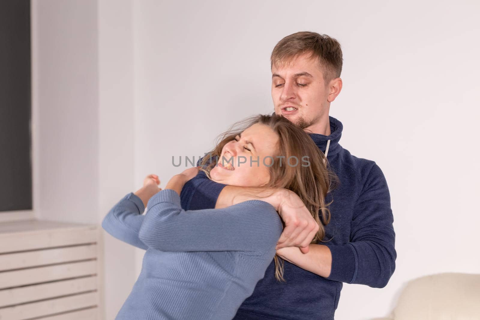 People, abuse and domestic violence concept - Portrait of man beating woman at home.