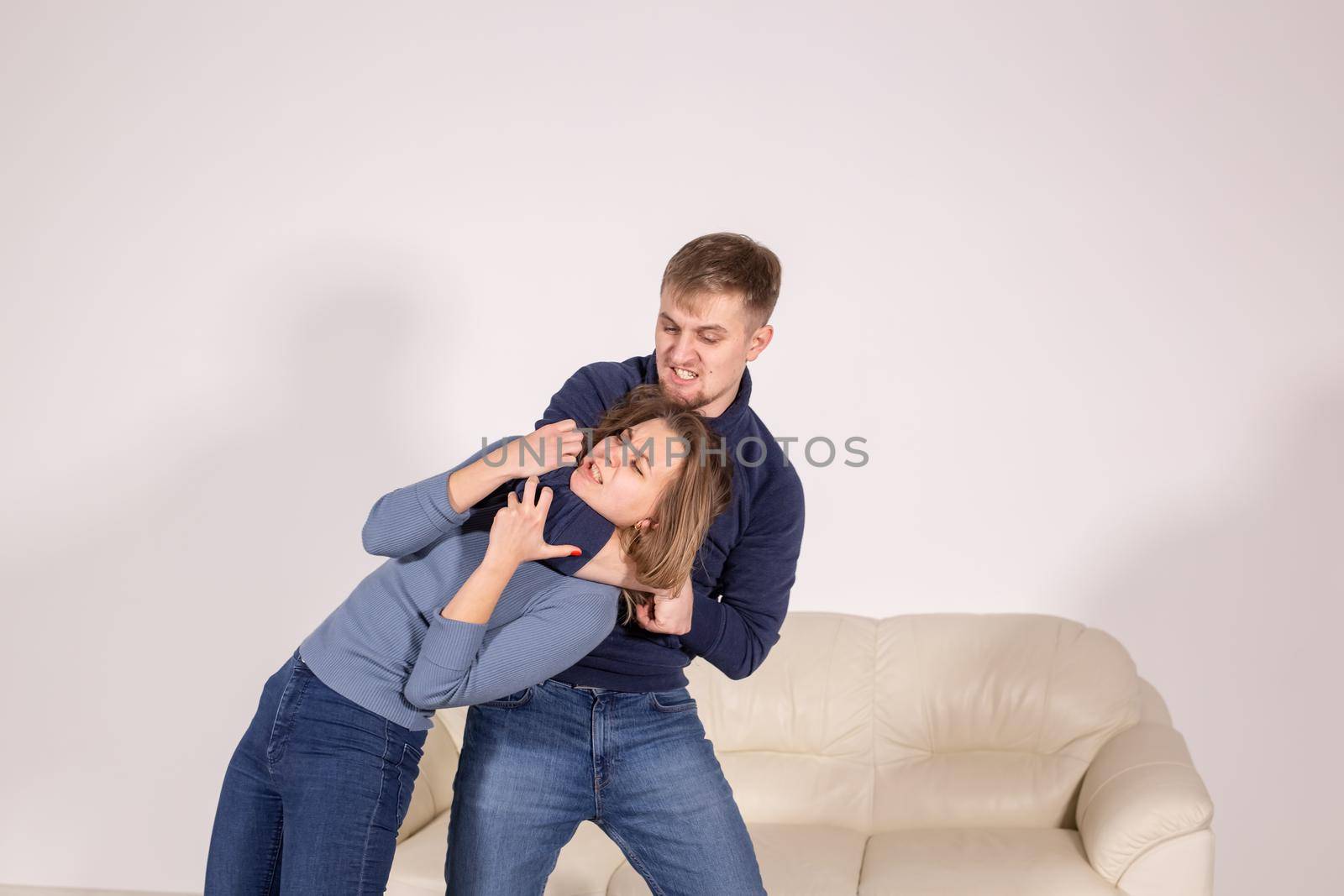 people, abuse and violence concept - agressive man strangling his wife by Satura86