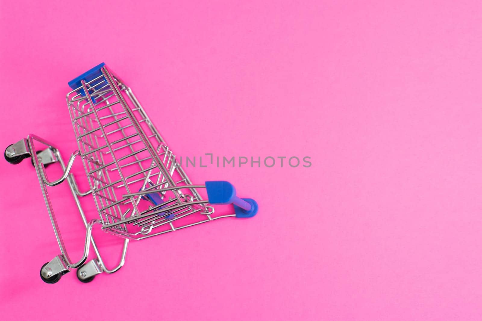 shopping cart isolated on pink background.