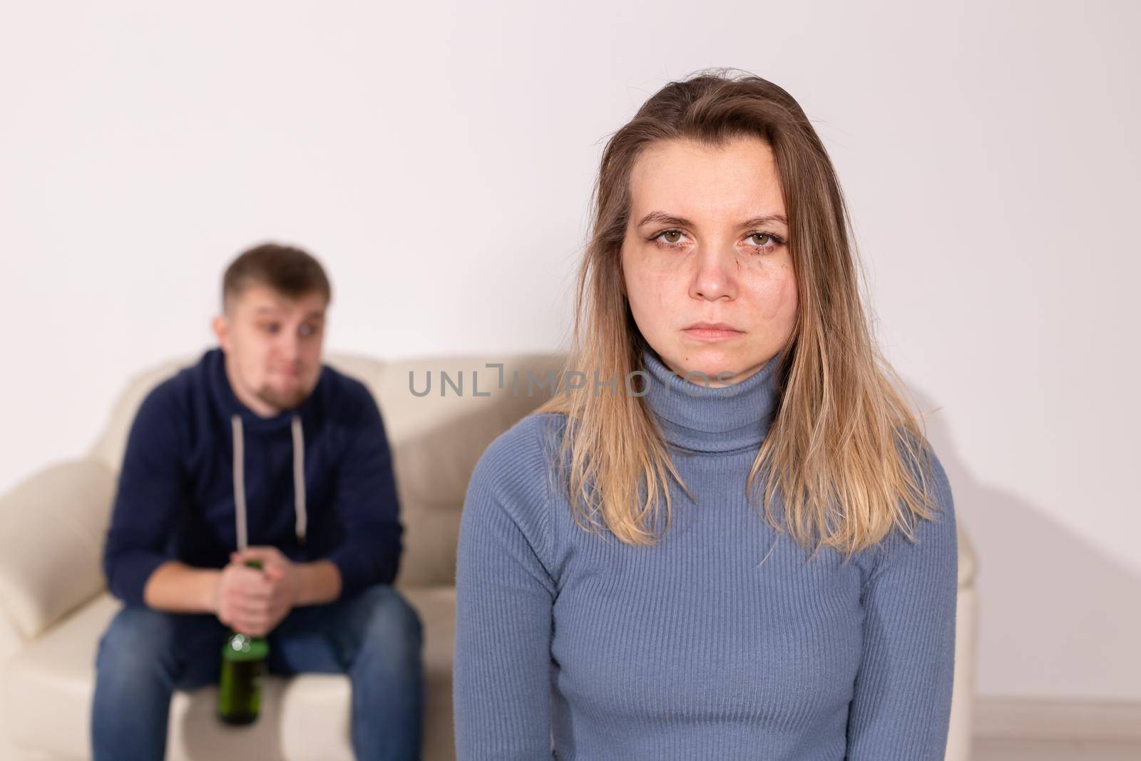 Alcoholism, abuse and domestic violence concept - sad woman with her drunk husband by Satura86