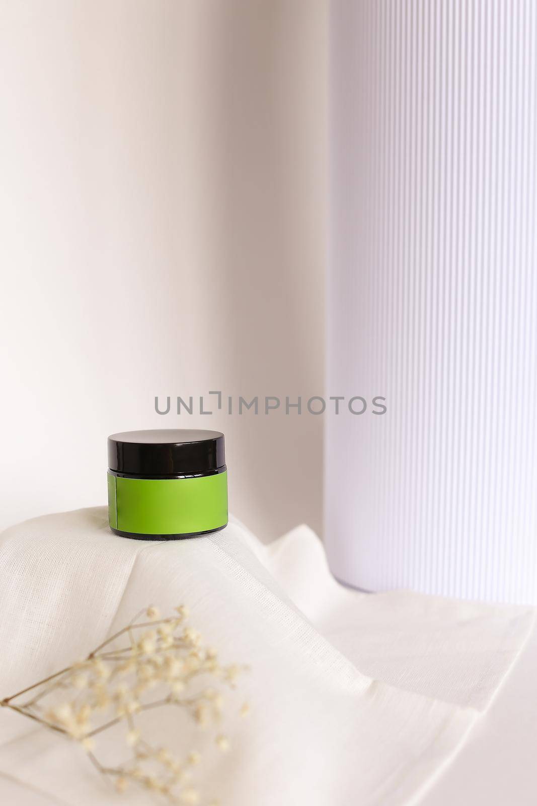 Focus on little jar of facial cream with green space for brand. by sisterspro