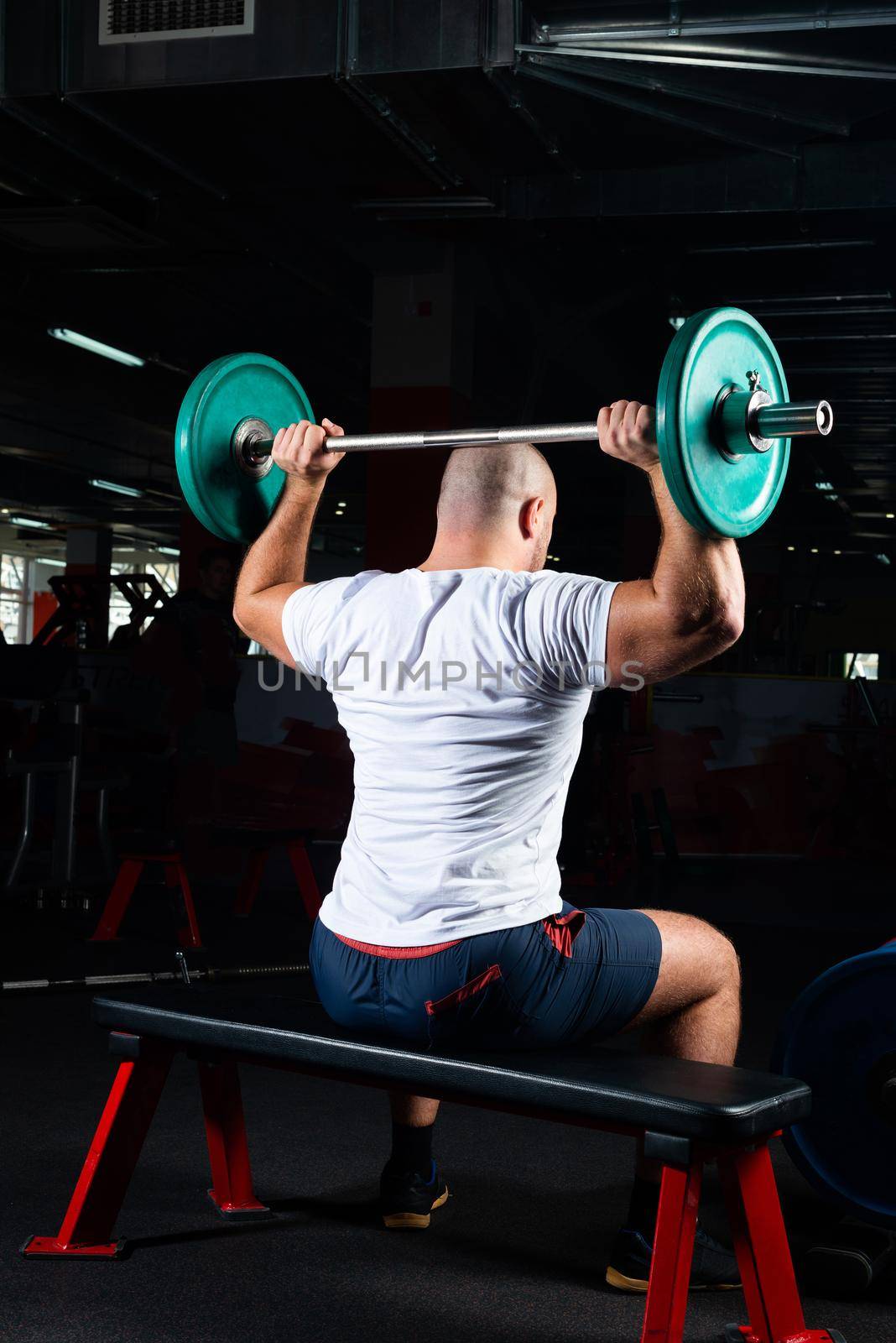 Male athlete lifts the barbell by adam121